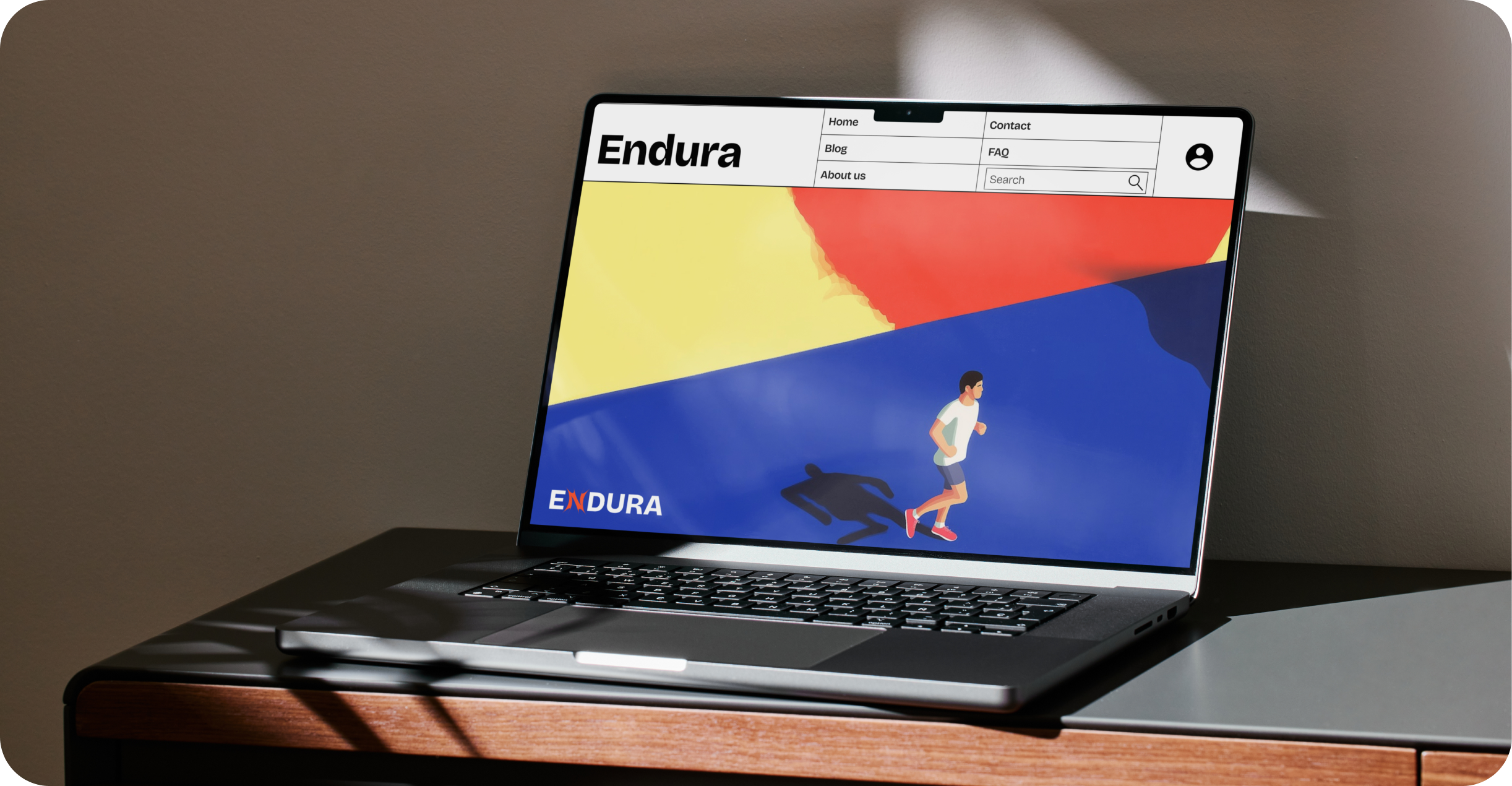 Laptop on table showing Endura website