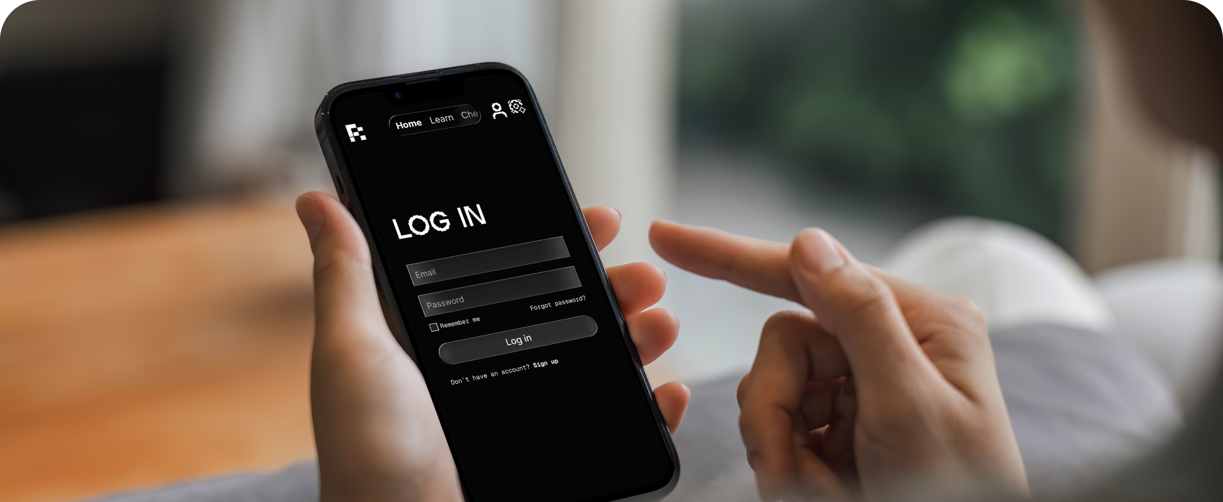 Hand holding phone showing Remnant login screen
