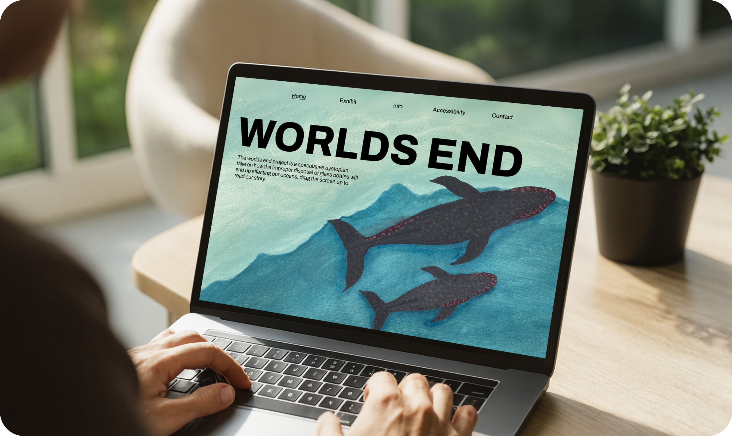 Laptop showing Worlds End website with whale illustrations